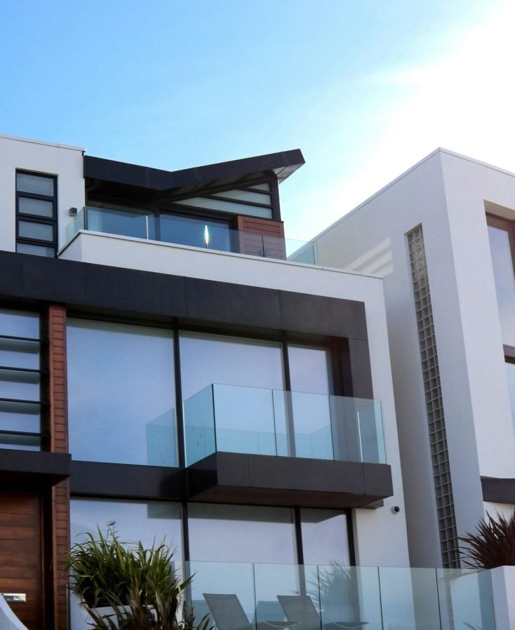 Contemporary luxury home with glass balconies in Poole, UK, showcasing modern architectural design.